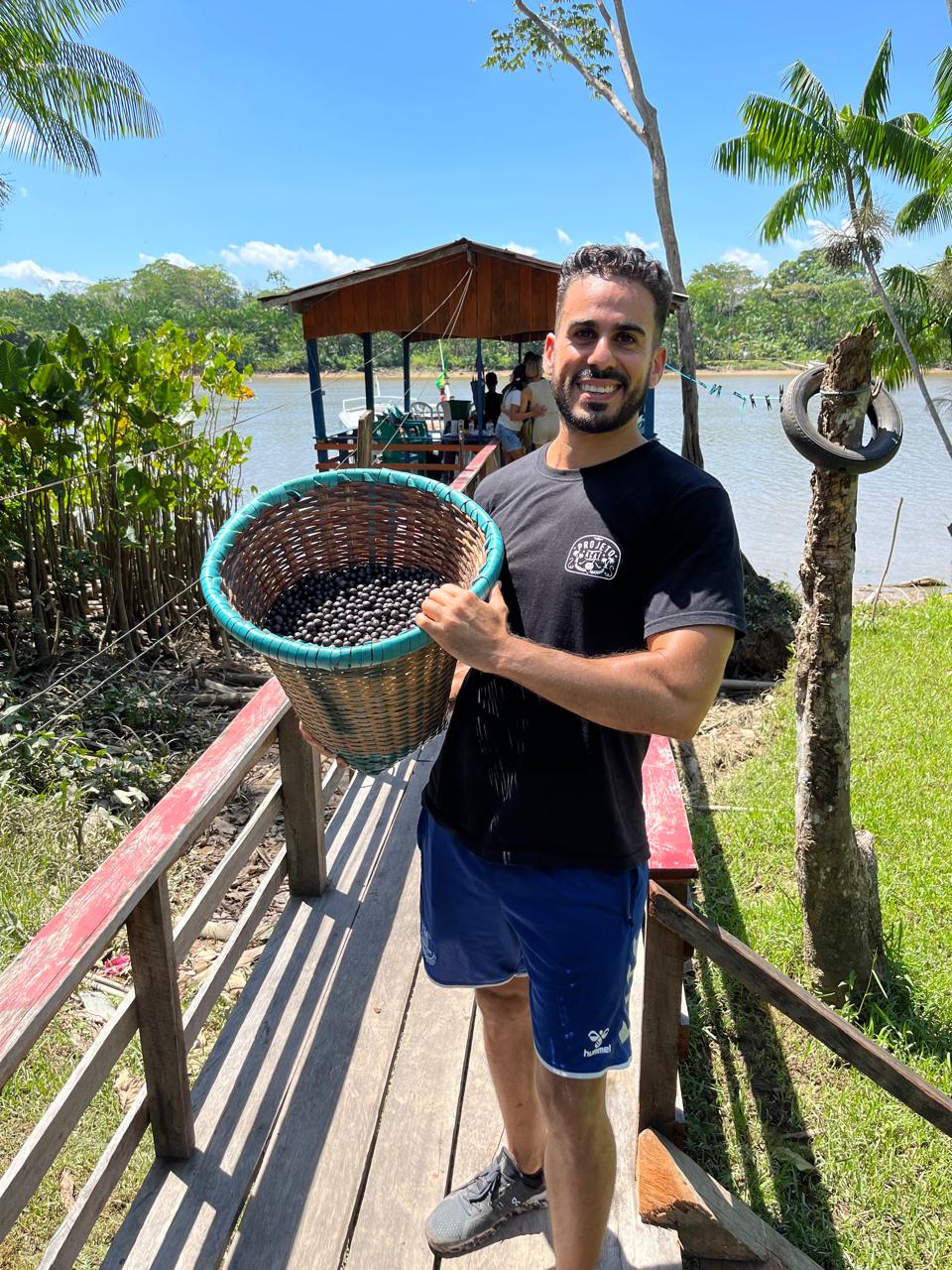 Ayman at the Amazon holding açaí basket